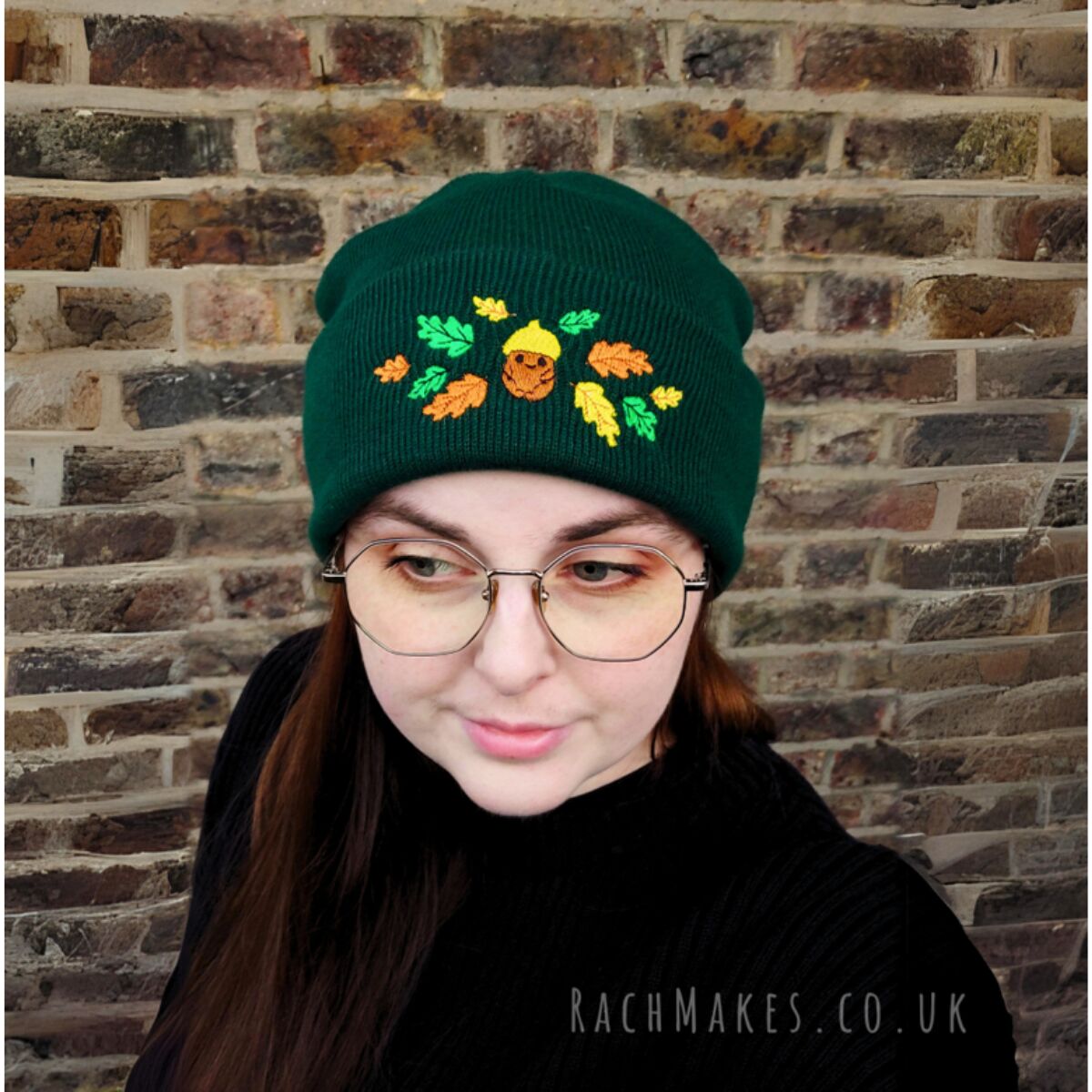 Rach wears a green beanie with a cute Acorn design. 